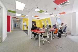 Create Business Hub - Brentwood Office Space For Rent - hot desk area brightly coloured with storm trooper statue.